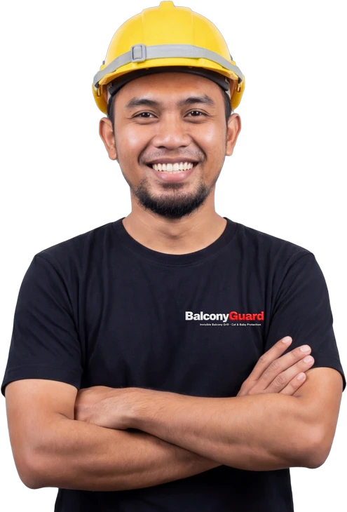 BalconyGuard installer in a yellow hard hat, arms crossed — invisible balcony grill Malaysia team