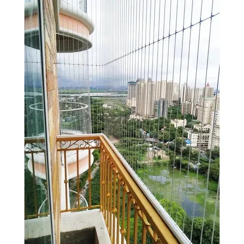 Technician installing invisible balcony grills on high-rise apartment units.